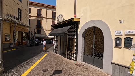 charming italian alleyway with shops and people