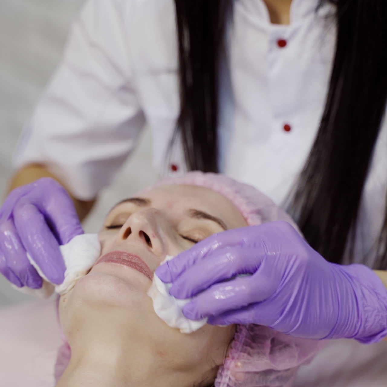 Young beautiful woman receiving facial massage and spa treatment. Cosmetology.