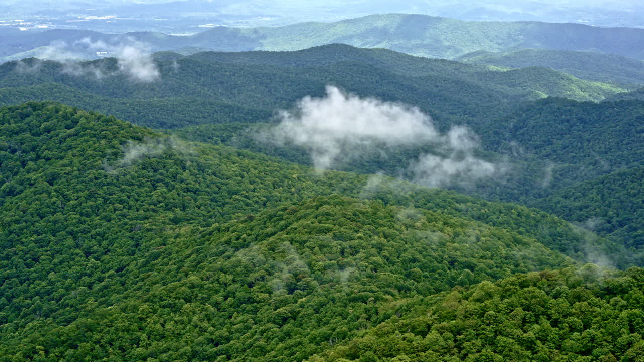 Heavy clouds and rain create a brooding tone in this Smoky Mountain flyover