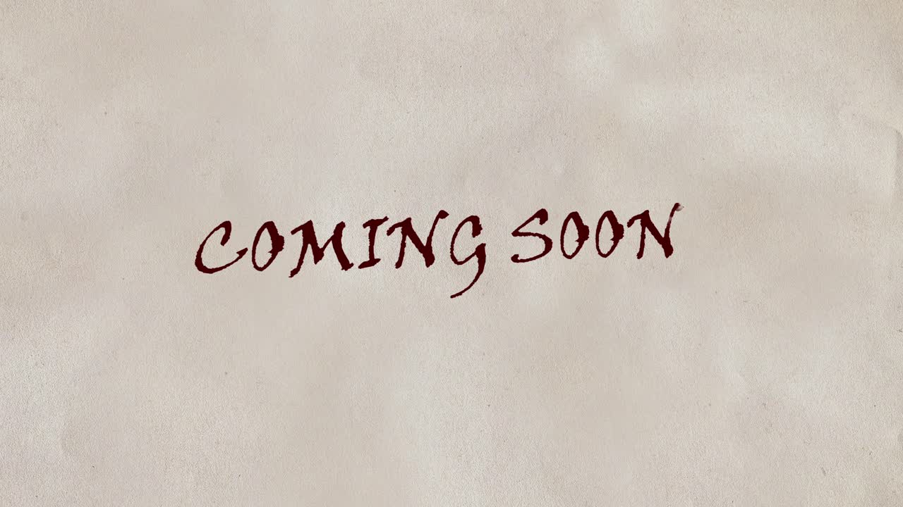 Red Ink Writing 'Coming Soon' on Textured Paper