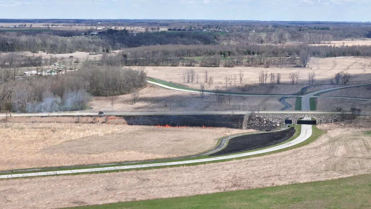Aerial shot of controlled burn to stop a wildfire.