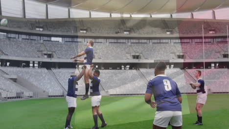 practicing lineout lift, rugby players in blue jerseys on green field