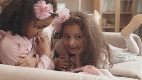 little girls using smartphone on couch