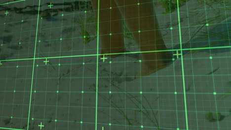 lower legs and bare feet walking across sandy dune ground under hud green grid overlay mapping
