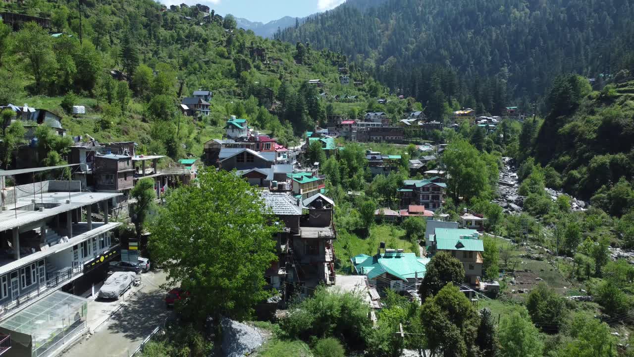 Aerial view short of Jibhi Himachal Pradesh in India. Houses and trees in the mountainous area. Faguli festival is one of the biggest festival in Jibhi. The traditional houses here have stone roofs.