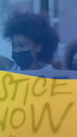 animation of flag of ukraine over diverse female and male protesters in face masks