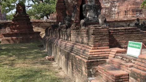 tilt shot of stone buddha and stupa in ayutthaya temple wat maha that ว ดมหาธาต