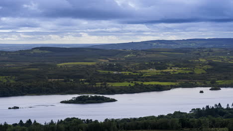 time lapse of rural farming landscape with lake, forest and hills during a cloudy day viewed from above lough meelagh in county roscommon in ireland