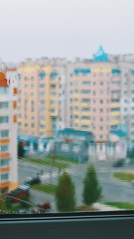 window cleaner working with wet glass window. close up view of cleaning window. vertical video
