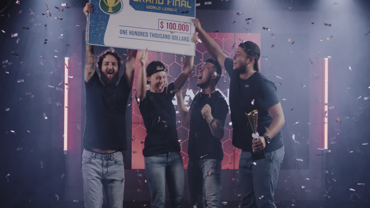 Gaming Tournament Team Celebrating their Victory Medium Shot of a Gaming Tournament Team Holding their Prize while Celebrating their Victory