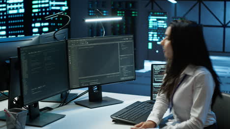 engineer in data center sitting down at desk, installing software