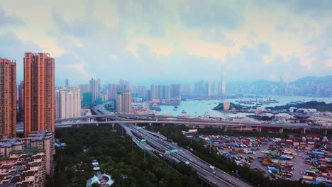 aerial view of hong kong lai chi kok park lingnan garden high-rise residential and commercial buildings mei foo sun chuen manhattan hill icc ifc during sunset