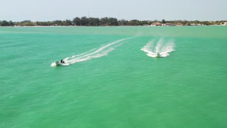 drone aerial video of speed boats off the coast of the gulf of mexico at sunset