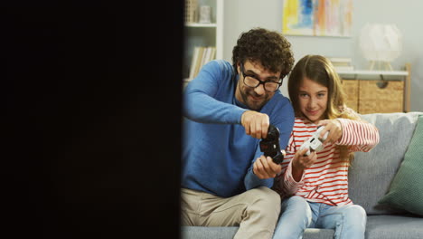Cheerful-Father-Playing-Videogames-Emotionally-Together-With-His-Cute-Daughter