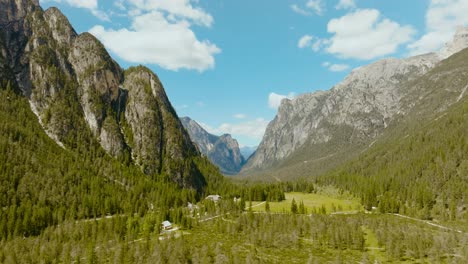 Aerial-drone-shot-of-the-Dolomites-alps-with-the-pine-forest-in-Italy,-4k