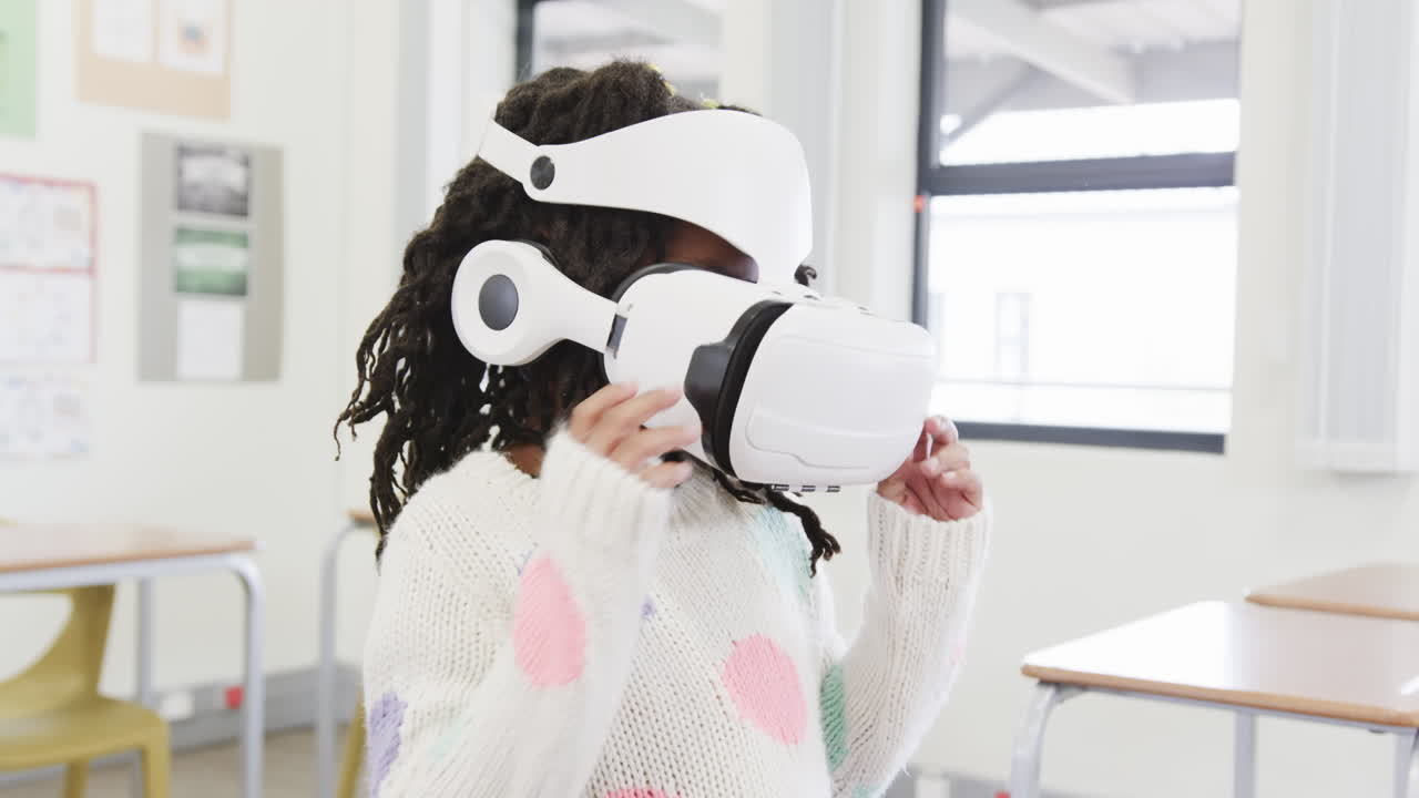 In school, young girl exploring virtual reality with headset in classroom