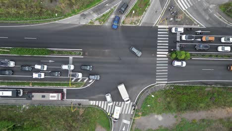 pull in drone shot of 4 way highway intersection traffic