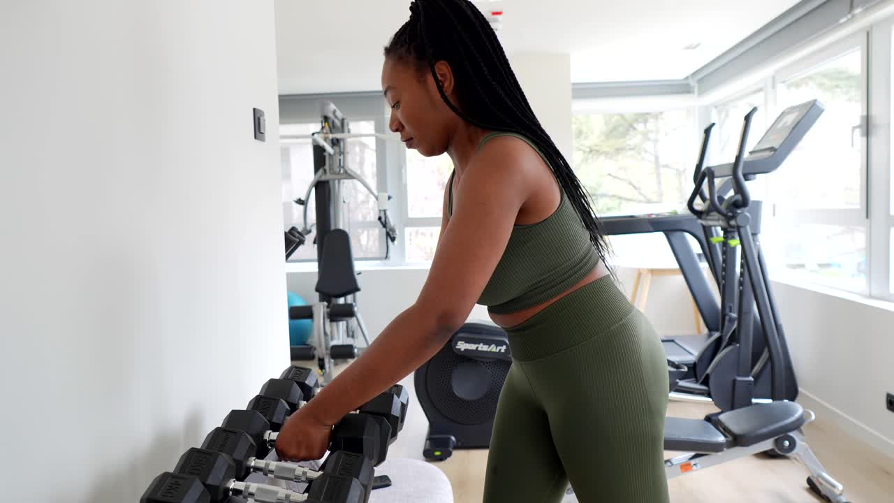 Woman working out with dumbbells at the gym