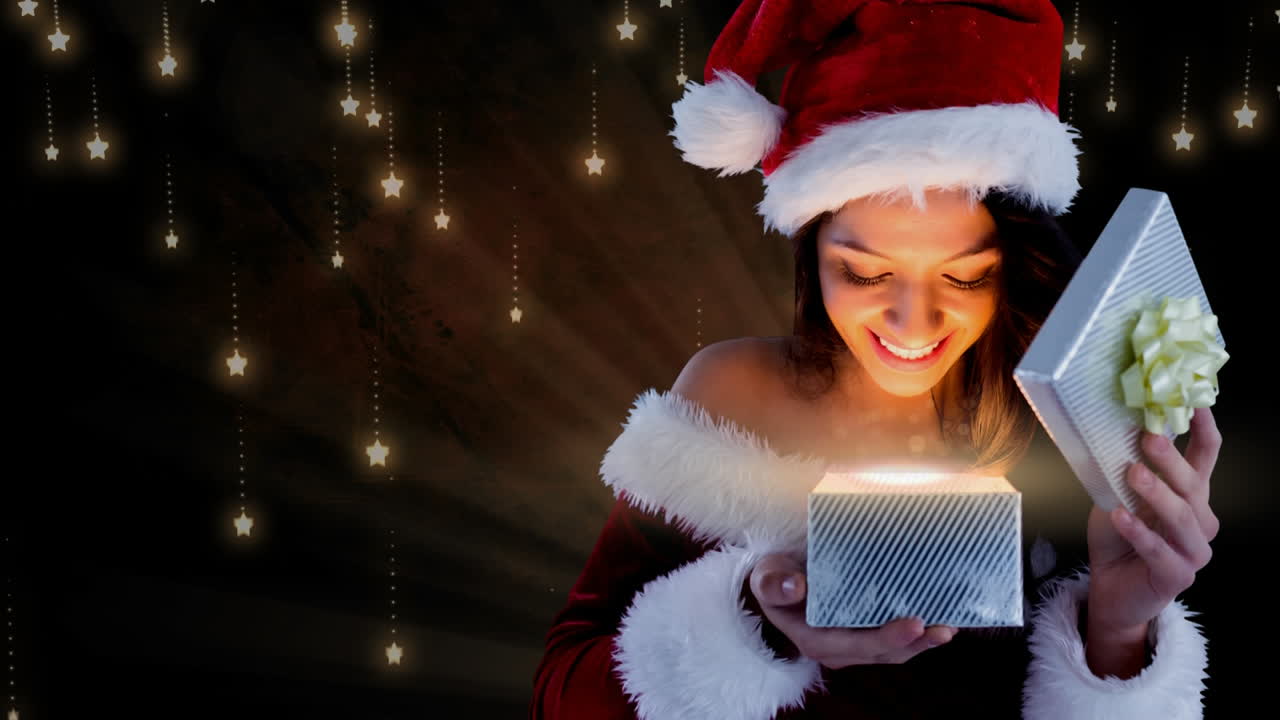 mujer de santa emocionada abriendo una caja mágica de regalos de navidad con copos de nieve