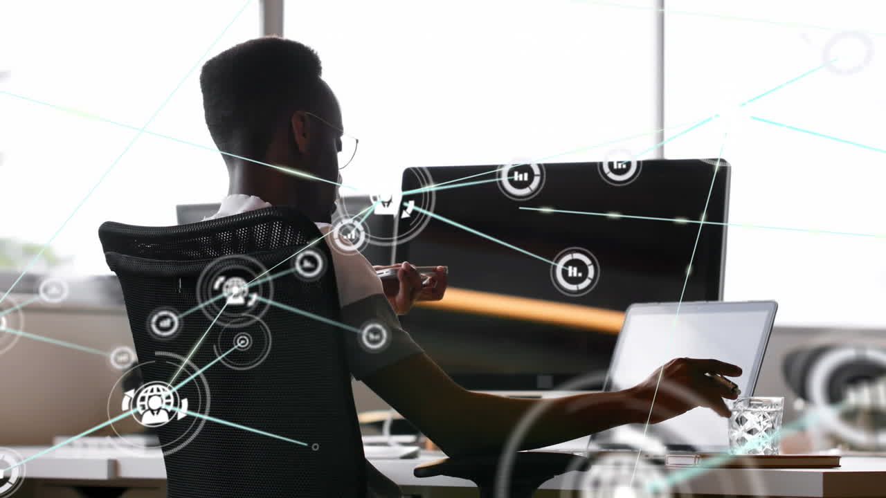 Animation of network of connections with icons over businessman using laptop