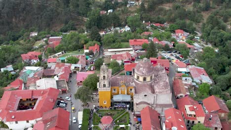 backwards-drone-shot-of-Mineral-del-chico-main-church-and-avenue