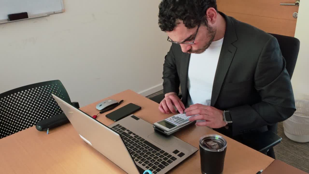 Young Businessman: Financial Calculations