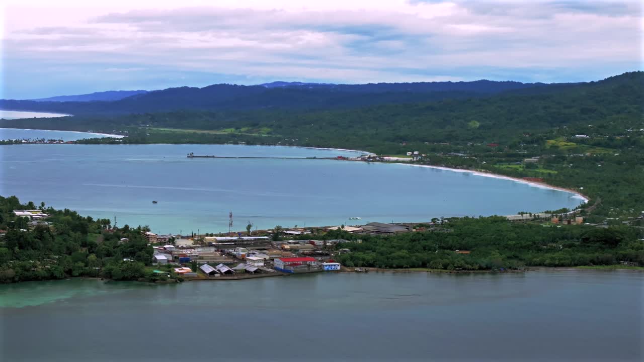 Sunny morning Wewak Papua New Guinea aerial drone dry season Boram Road Memorial drive Wewak Hill costal town Wewak Seawall Mini Beach Dogreto Bay shipwreck Sundaun Market parallax circle right motion