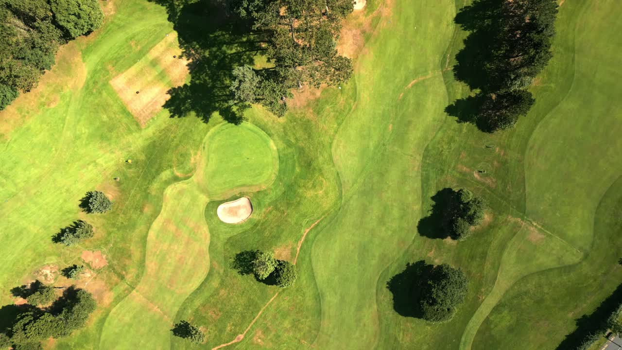 Descending 4K 60FPS aerial of Helen's Bay Golf Club in County Down, Northern Ireland on a bright summer day. Produced with Rec709 color