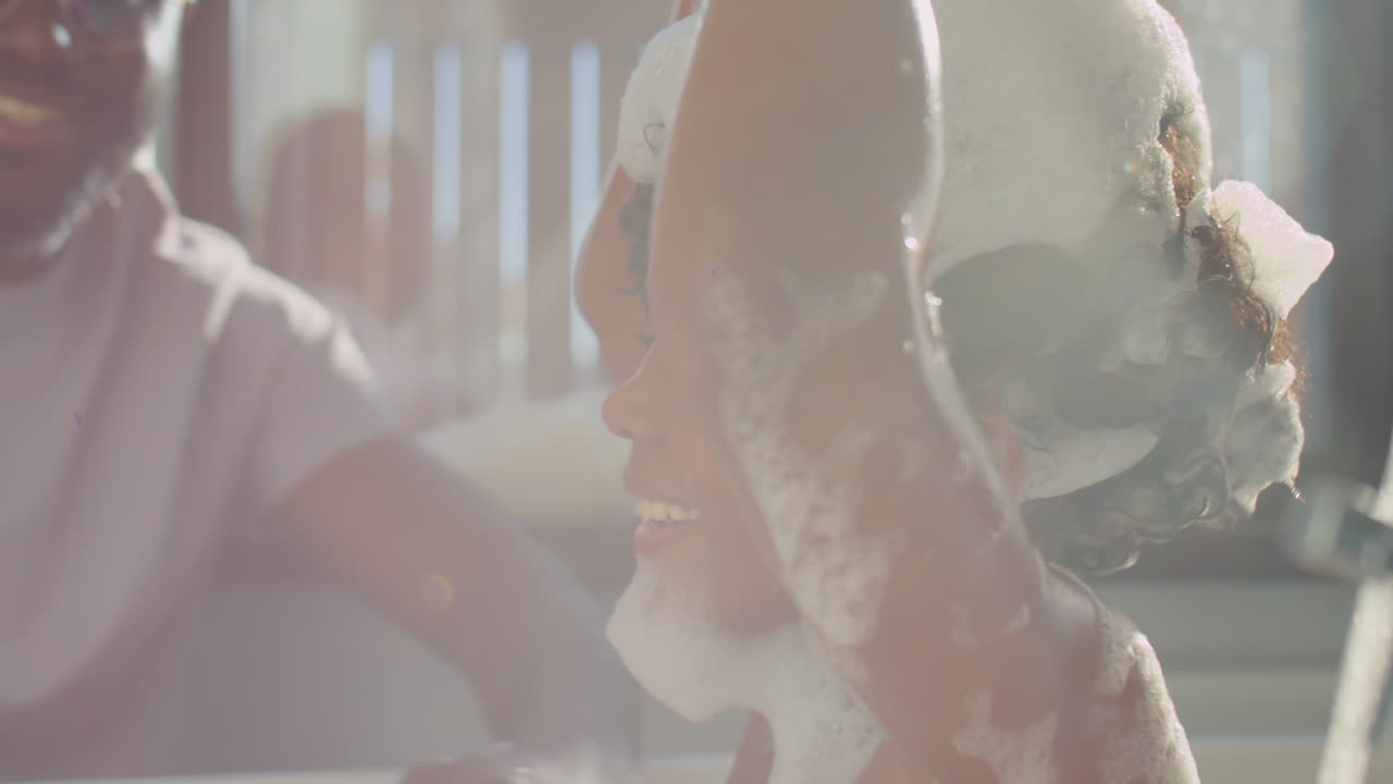 Little Boy Playing with Foam while Bathing with Dad
