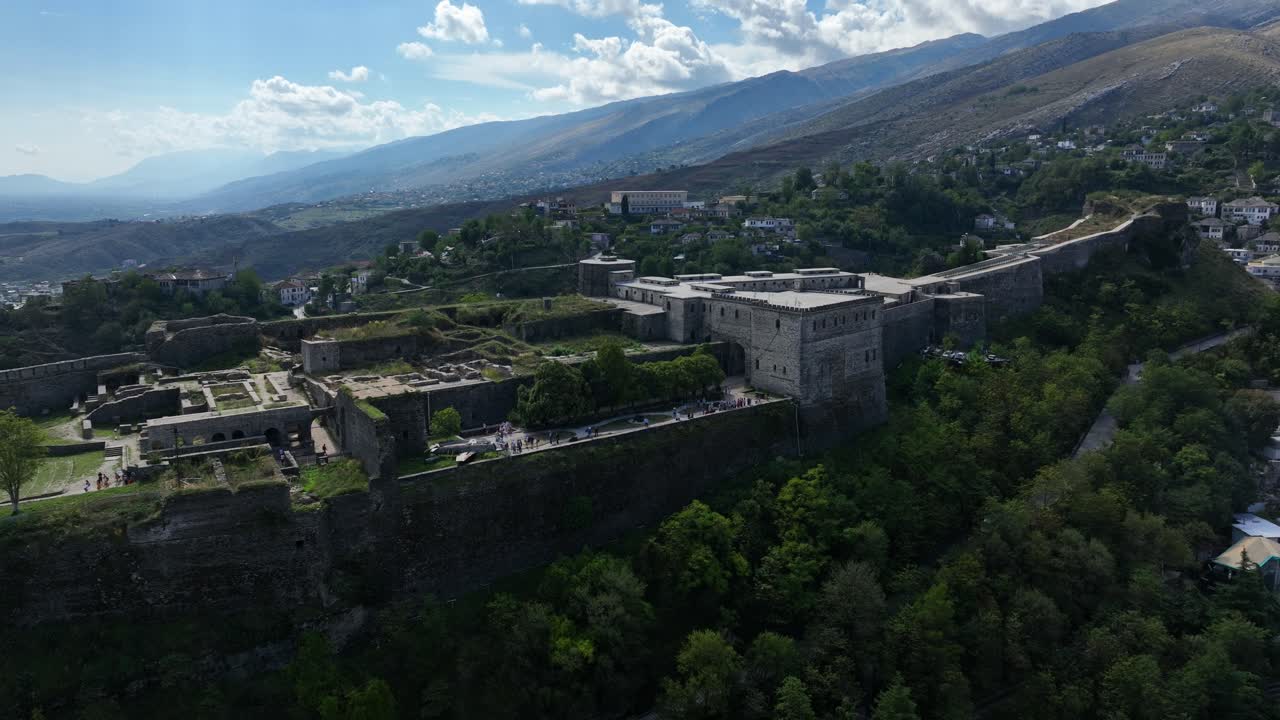 Castle of Gjirokastra And Cityscape With Mountainscape Surroundings In Gjirokastër, Albania. Aerial Drone Shot
