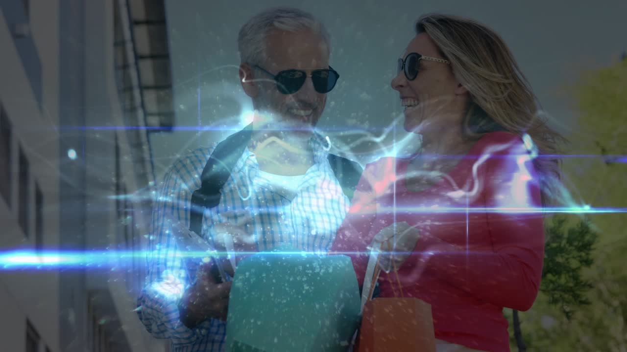 Animazione di scie luminose su coppia caucasica anziana che usa un tablet