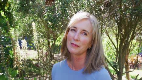 portrait of senior caucasian woman smiling in a sunny garden