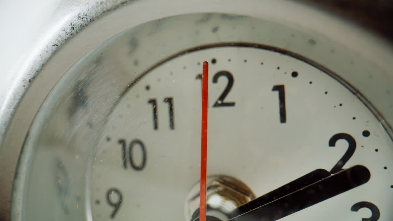 Closeup arrow measuring seconds at round clock indoors. Macro arrows running