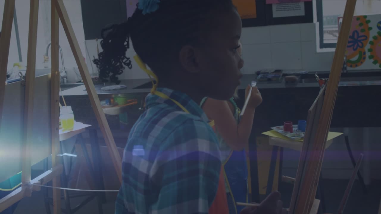 Animation of colourful squares over male student using laptop