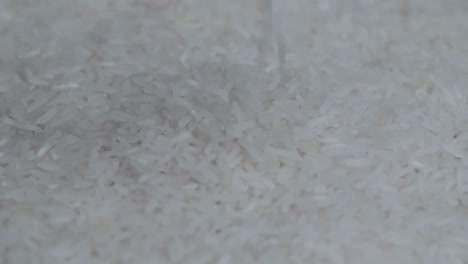 close up of white rice falling rotate slow motion