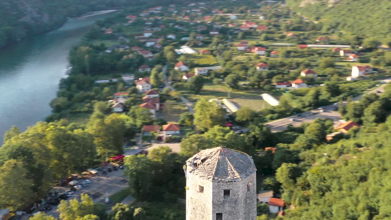 Aerial circling view of Pocitelj tower and river Neretva