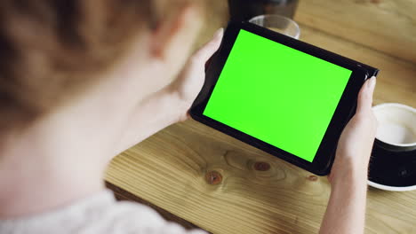 Green-screen-hands-using-digital-tablet-touchscreen-device-ipad-in-cafe