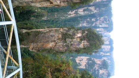 stunning aerial view of a metal bridge across a deep valley in zhangjiajie, china
