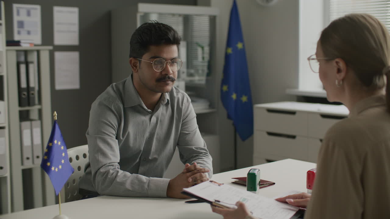 Indian Man Having Interview with Female Visa Officer at European Union Embassy