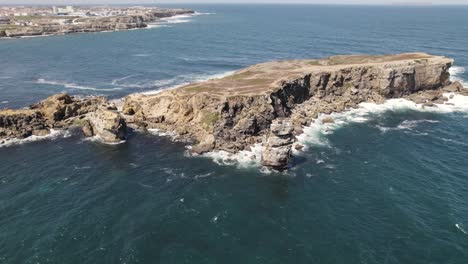 atlantic sea waves crashing on rocky headland cliffs, peniche, portugal