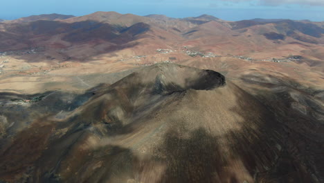 gairia volcanic caldera: aerial view in a circle over the caldera on a sunny day and on the island of fuerteventura