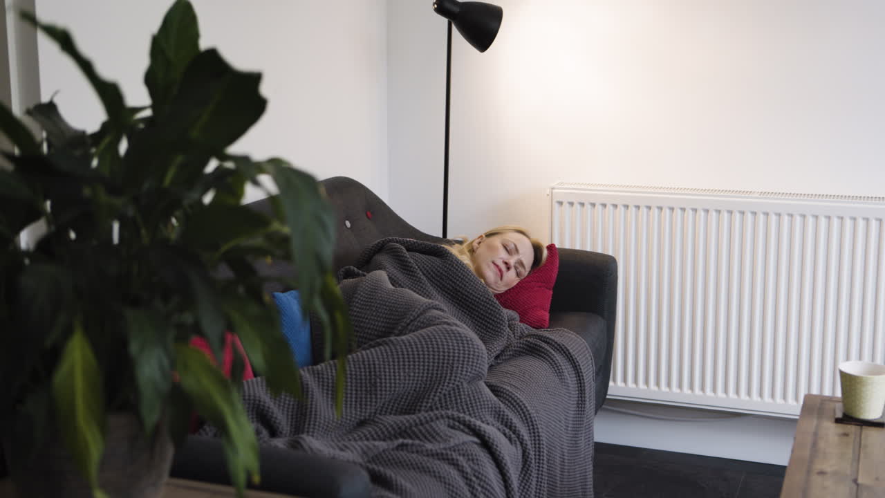 Woman Sleeping on Couch with Blanket