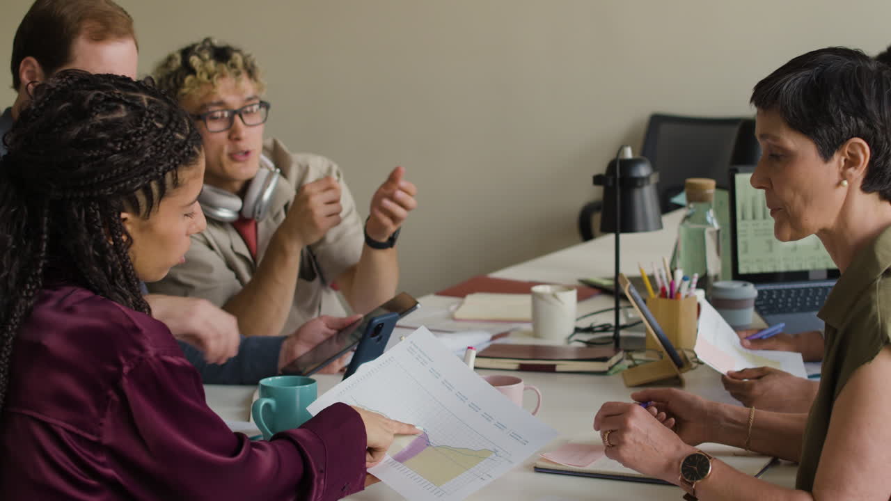 Diverse Business Team Collaborating and Discussing Data in an Office Meeting