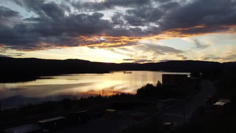 Flying-through-trees-to-reveal-a-fantastic-sunset-over-a-lake-in-Norway