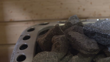 pouring water on the rocks from a sauna heater