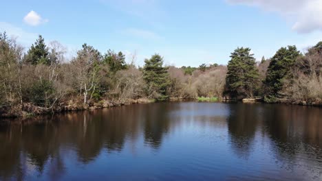 calm reflective squabmoor reservoir located in woodbury common, east devon