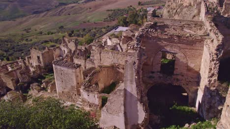 Broken-buildings-on-hill-top-village-Craco-in-Italy,-aerial