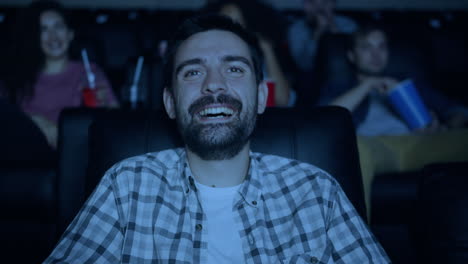 man laughing in movie theater