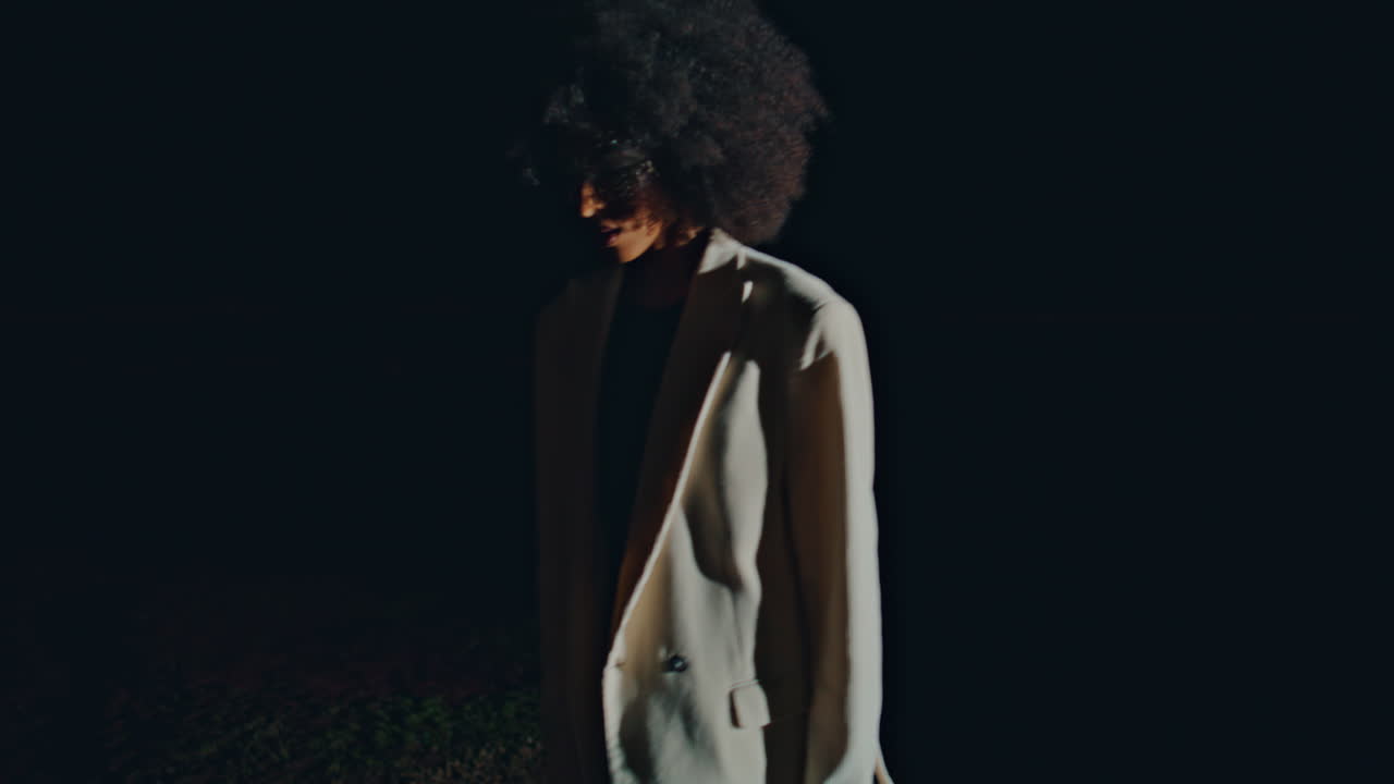 Attractive model posing dark background. Gorgeous   walking water