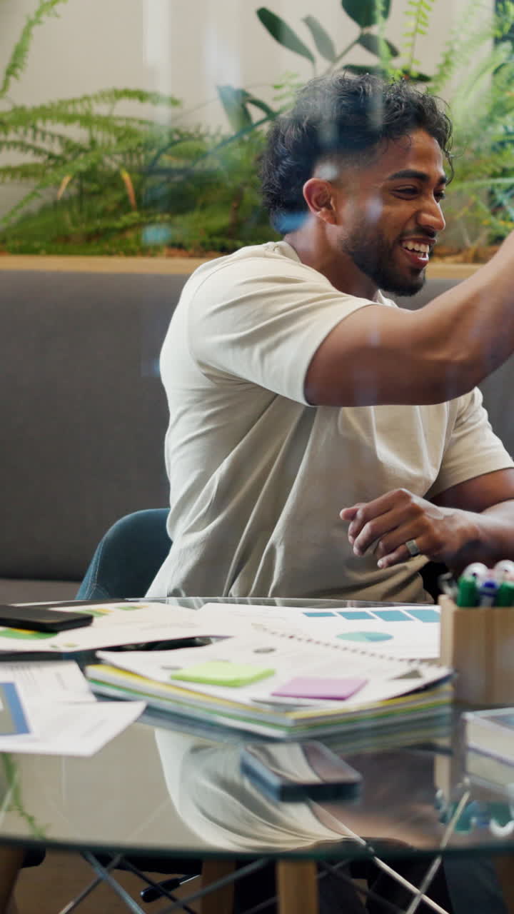 Happy Young Man Clapping and High-Fiving in an Office Meeting